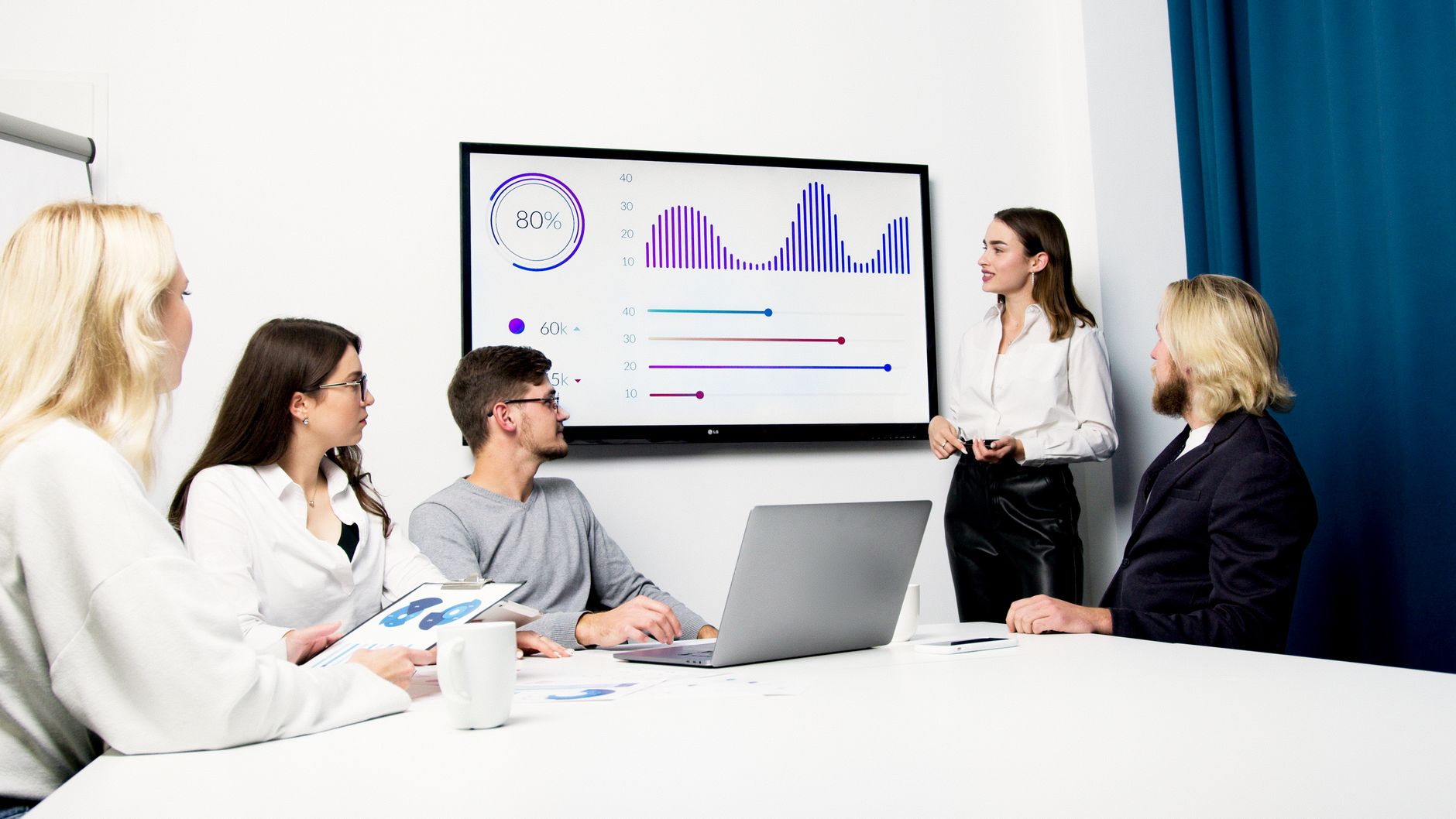 Corporate meeting room presentation screen with data metrics