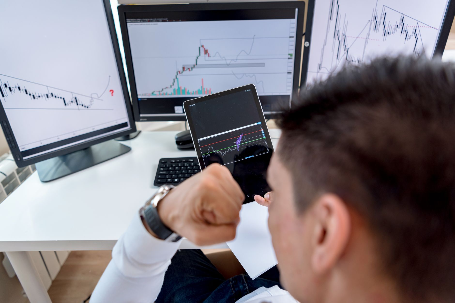 Finance analyst reviewing tablet stock indicators